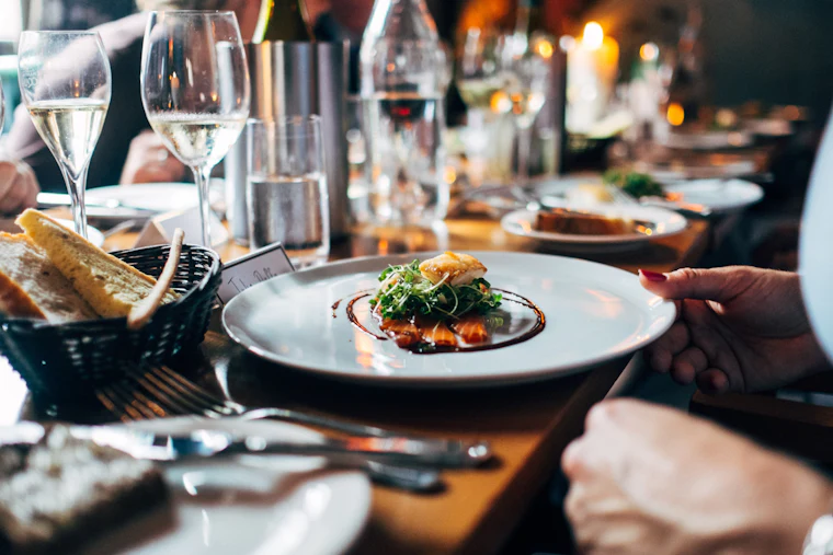 A warm restaurant table set for dinner among friends