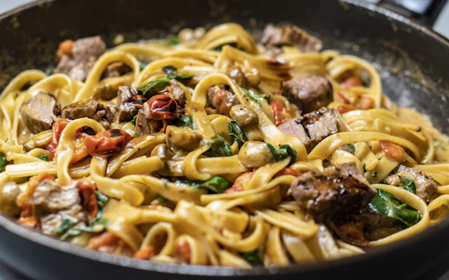 Pan of fresh tagliatelle in a rich sauce